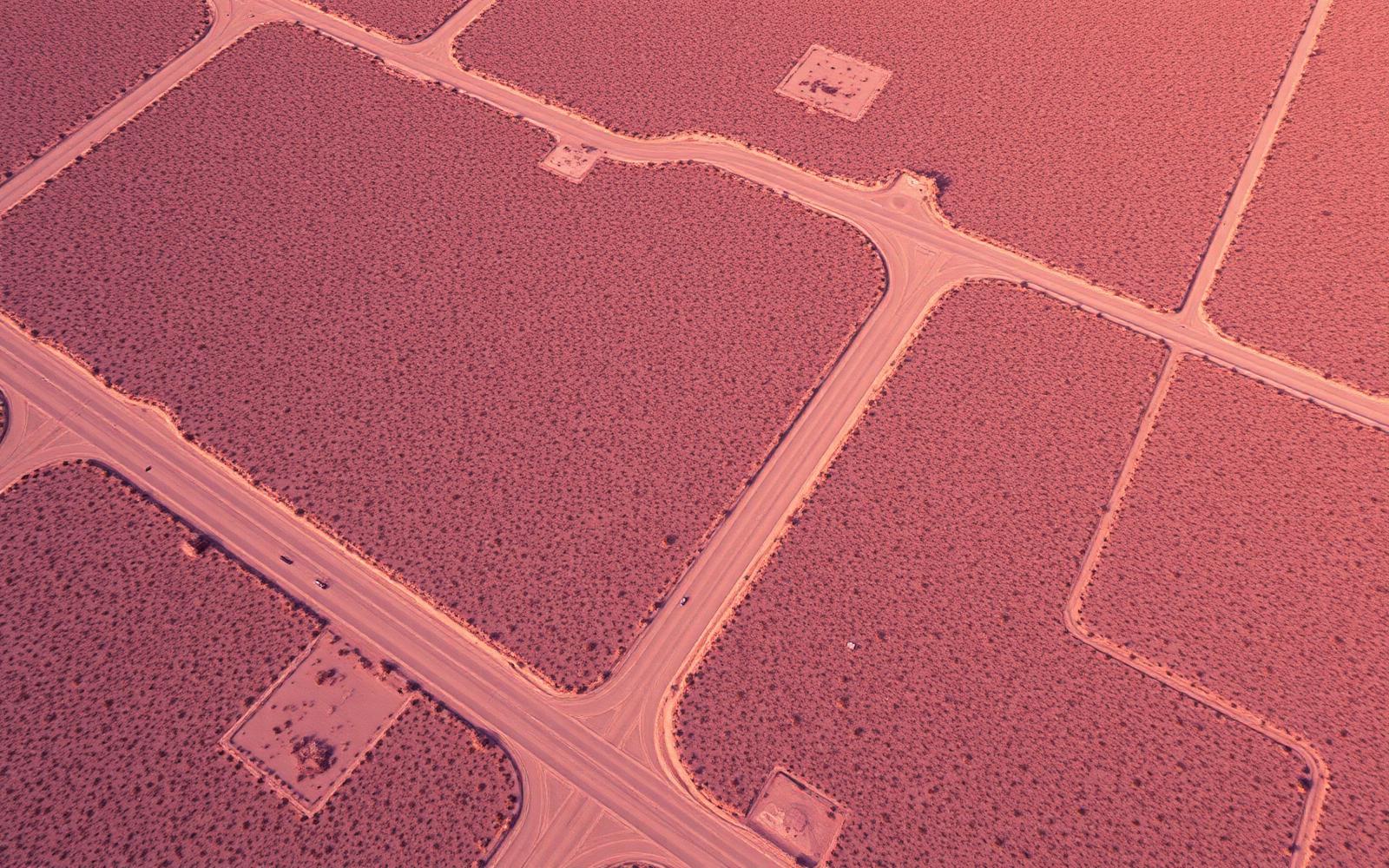 Aerial view of vacant land parcels divided by roads